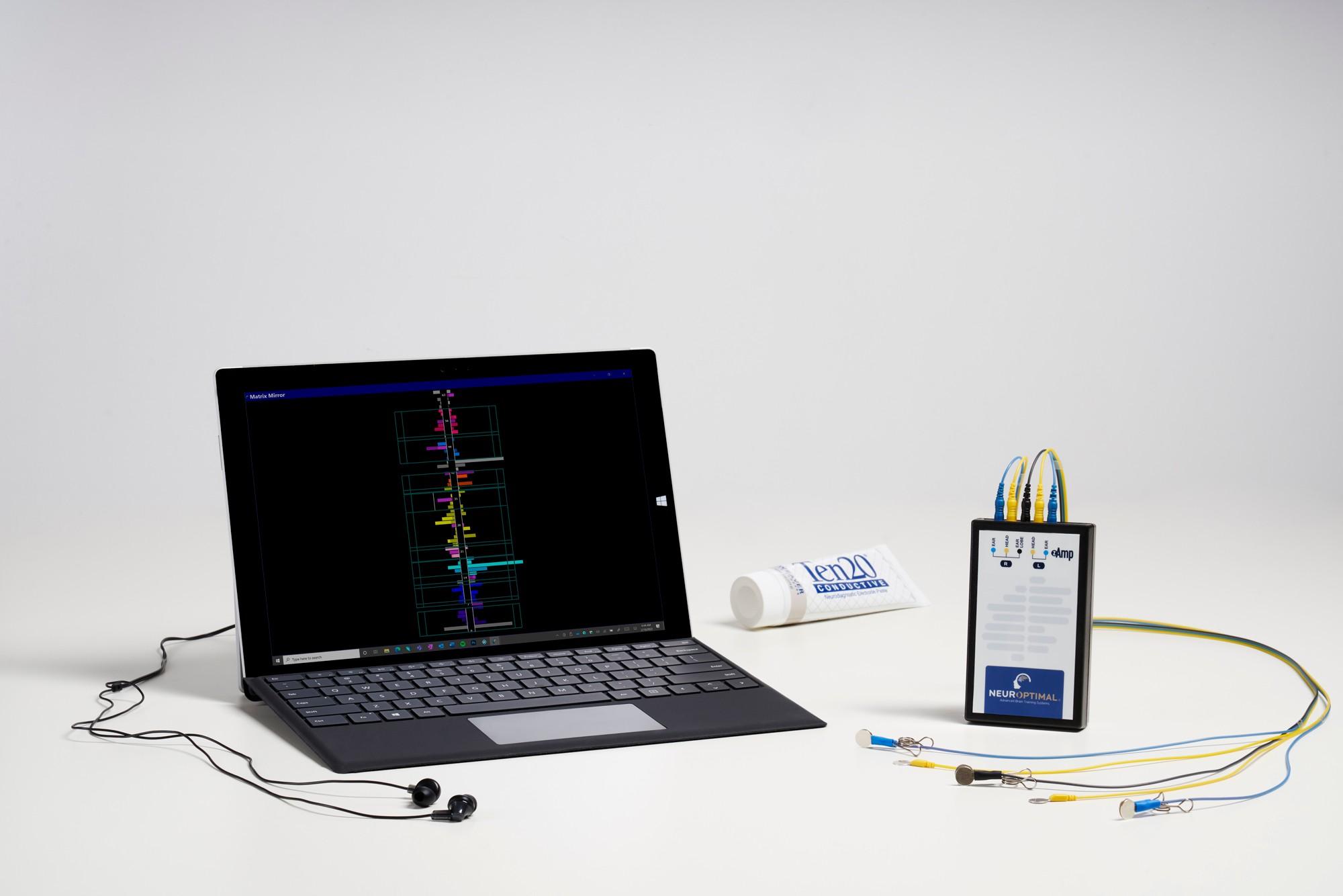 NeurOptimal system: tablet, earbuds, sensors and zAmp
