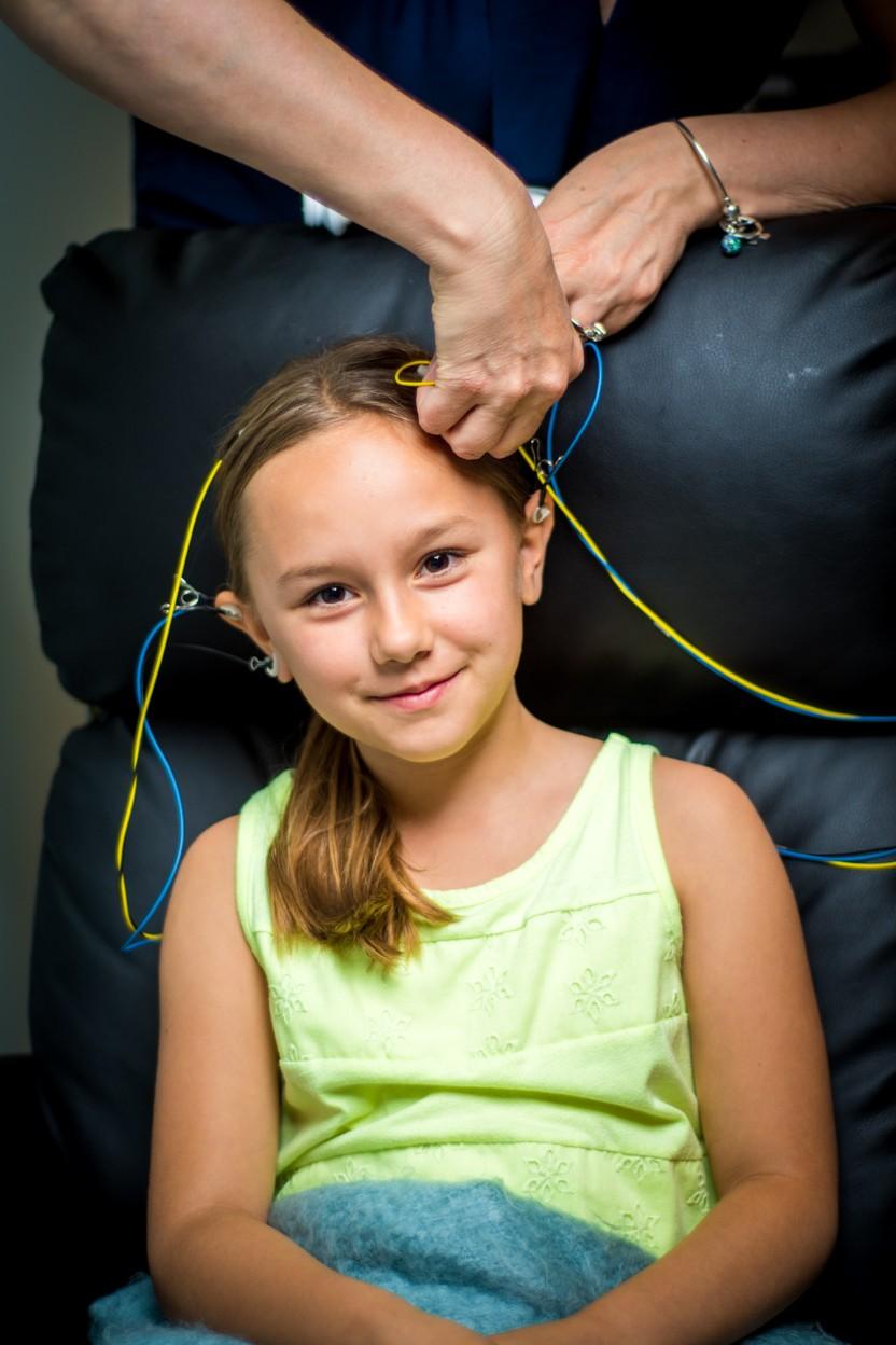 A smiling girl as a trainer sets up her sensors